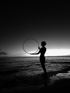 a girl holding a hoop in twilight
