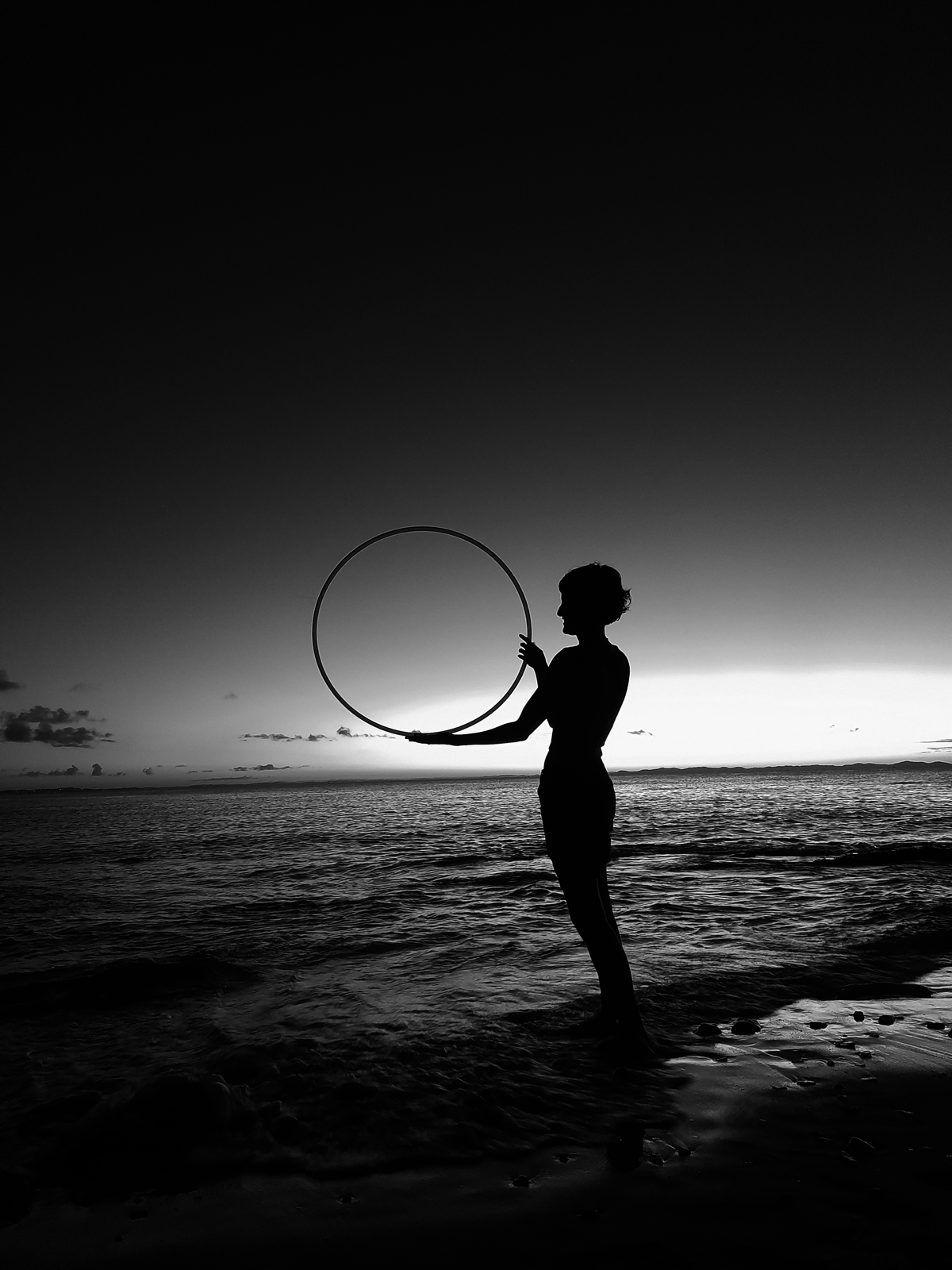 a girl holding a hoop in twilight